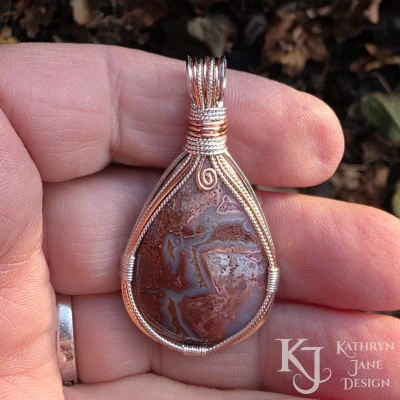 The warmth of the crazy lace agate is brought to the fore by the inclusion of copper in the sterling silver design