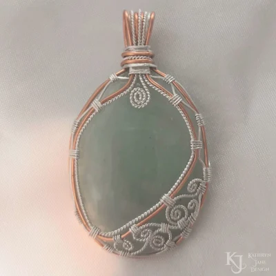  Light green aventurine with ornate sterling silver swirls supported by a copper and Argentium sterling silver framework.