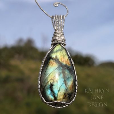 Symmetrical Argentium sterling silver design around this flashy pear-shaped labradorite pendant.