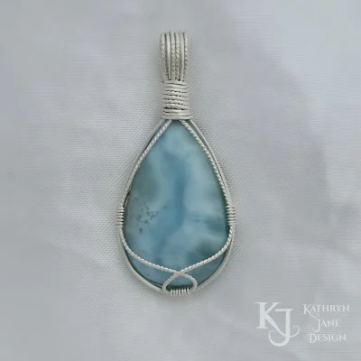 Flowing twisted silver enhancing a free, flowing support of the larimar