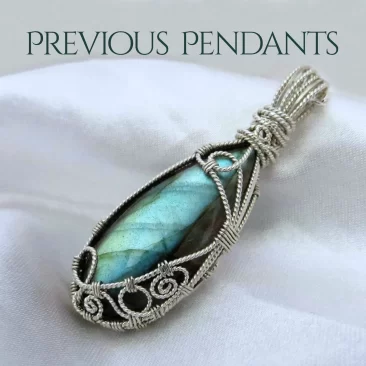 Previous pendants, portfolio category header page. Beautiful labradorite gemstone crystal pendant with ornate silverwork, lovingly handcrafted. White satin background.