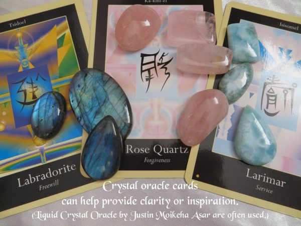 Finding it hard to choose? The cards can be a fun place to start. Finding it hard to choose which gemstone you'd like as a pendant? Liquid Crystal Oracle cards by Justin Moikeha Asar can be a helpful start to provide inspiration.Oracle cards of labradorite, free will, rose quartz, forgiveness and larimar service, with actual gemstone crystals of the same type on top of them.