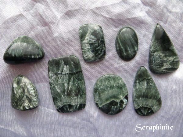 Seraphinite Seraphinite gemstone crystals. Six cabochons and two tumbled stones. Shapes include ovals, peardrops and oblongs. Dark green with appearance of pale green wings, hence the association with seraphim angels.