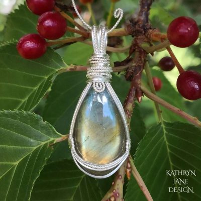 Sweet wee teardrop labradorite pendant, with symmetrical supports of sterling and Argentium sterling silver.