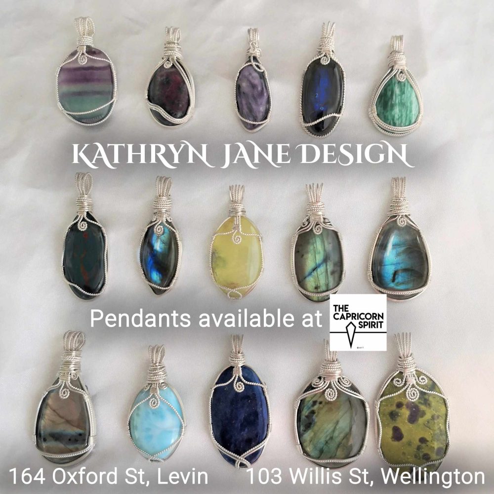 Kathryn Jane Design pendants available at The Capricorn Spirit, Levin and Wellington. Writing with gemstone crystal pendants behind on a white background.
