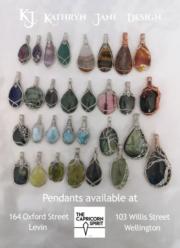 Kathryn Jane Design pendants available at The Capricorn Spirit, Levin and Wellington. background. Kathryn Jane Design pendants available at The Capricorn Spirit, Levin and Wellington. Writing with gemstone crystal pendants behind on a white background.