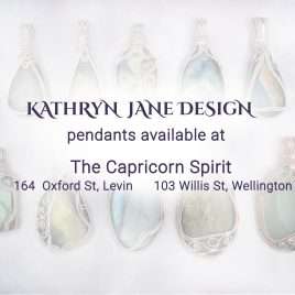 Kathryn Jane Design pendants available at The Capricorn Spirit, Levin and Wellington. Writing with gemstone crystal pendants behind on a white background.