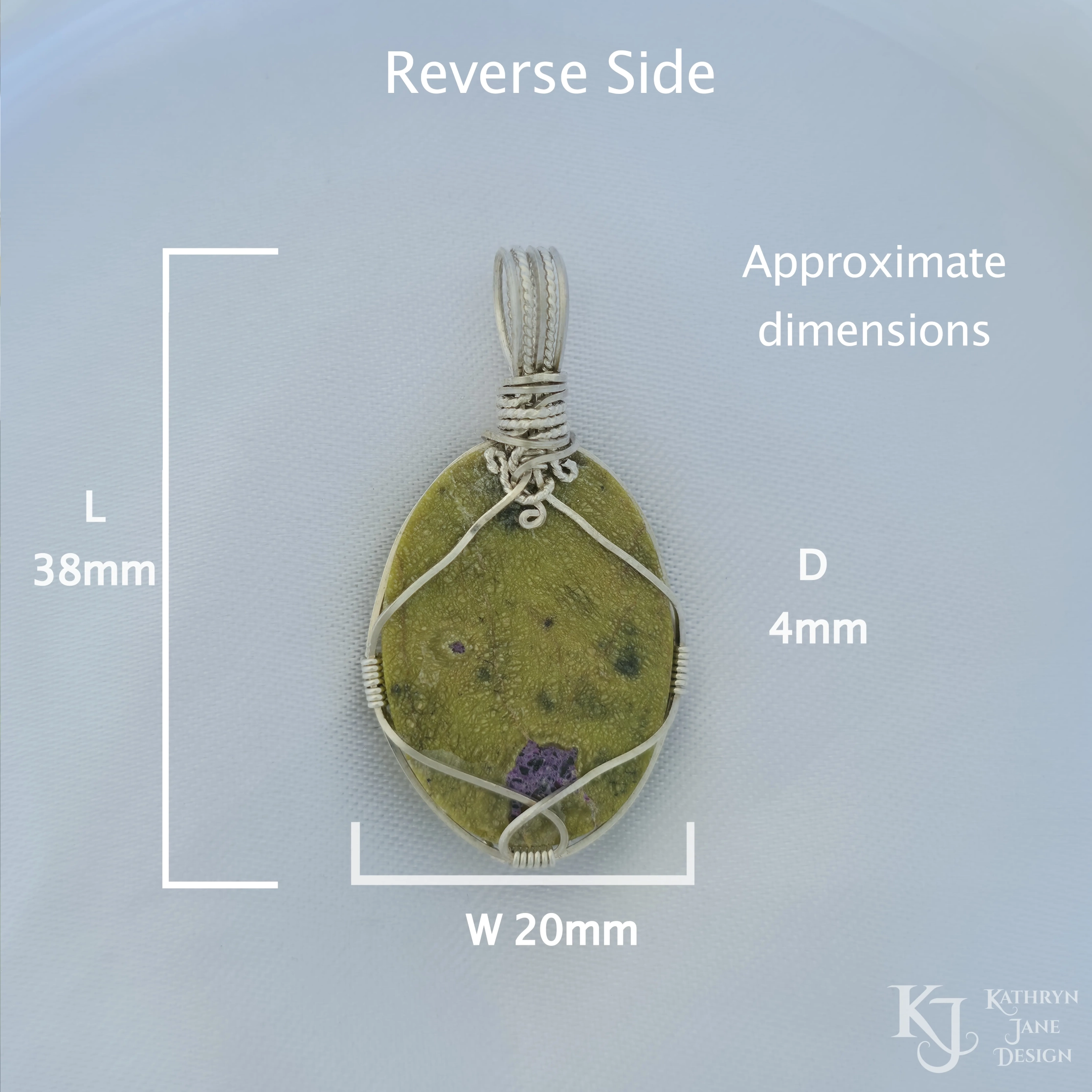 Kathryn Jane Design wire-wrapped Atlantisite pendant with sterling silver forming a framework. Purple stichtite in the middle of the green serpentine. White background. Reverse side. Length 38mm, width 20mm, depth 4mm