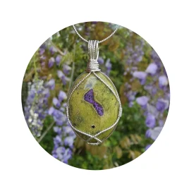 Kathryn Jane Design wire-wrapped Atlantisite pendant with sterling silver forming a framework. Light purple flowers accent the purple stichtite in the middle of the green serpentine