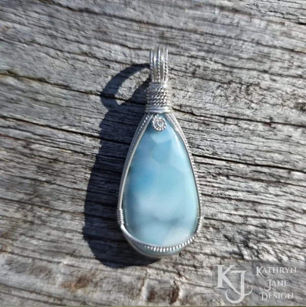 Peardrop-shaped larimar pendant, soft blue-turqoise, framed in sterling silver wire. Kathryn Jane Design wire wrapped pendant.