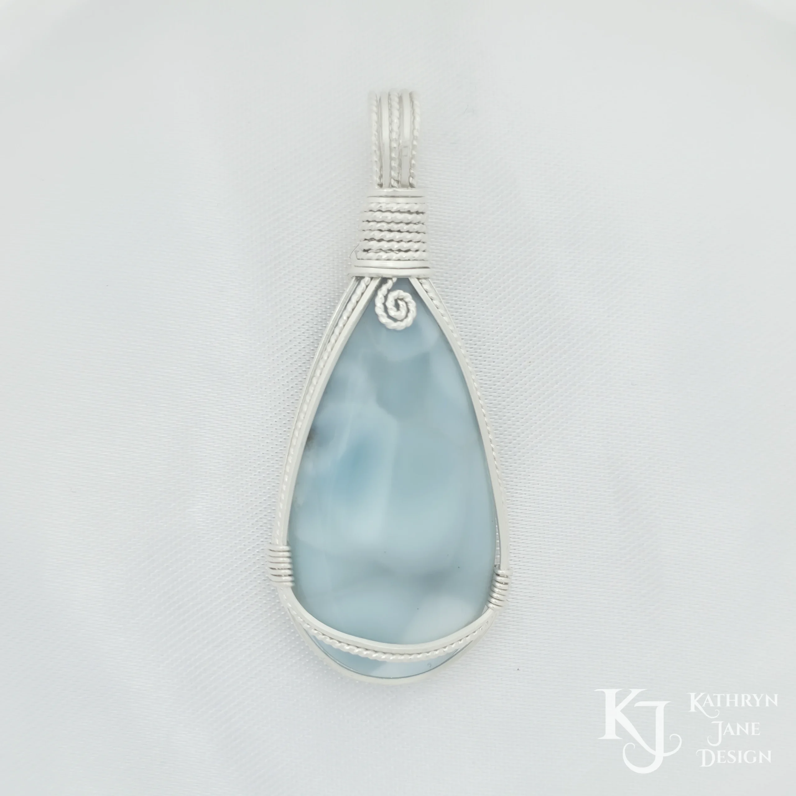 Peardrop-shaped larimar pendant, soft blue-turqoise, framed in sterling silver wire. Kathryn Jane Design
