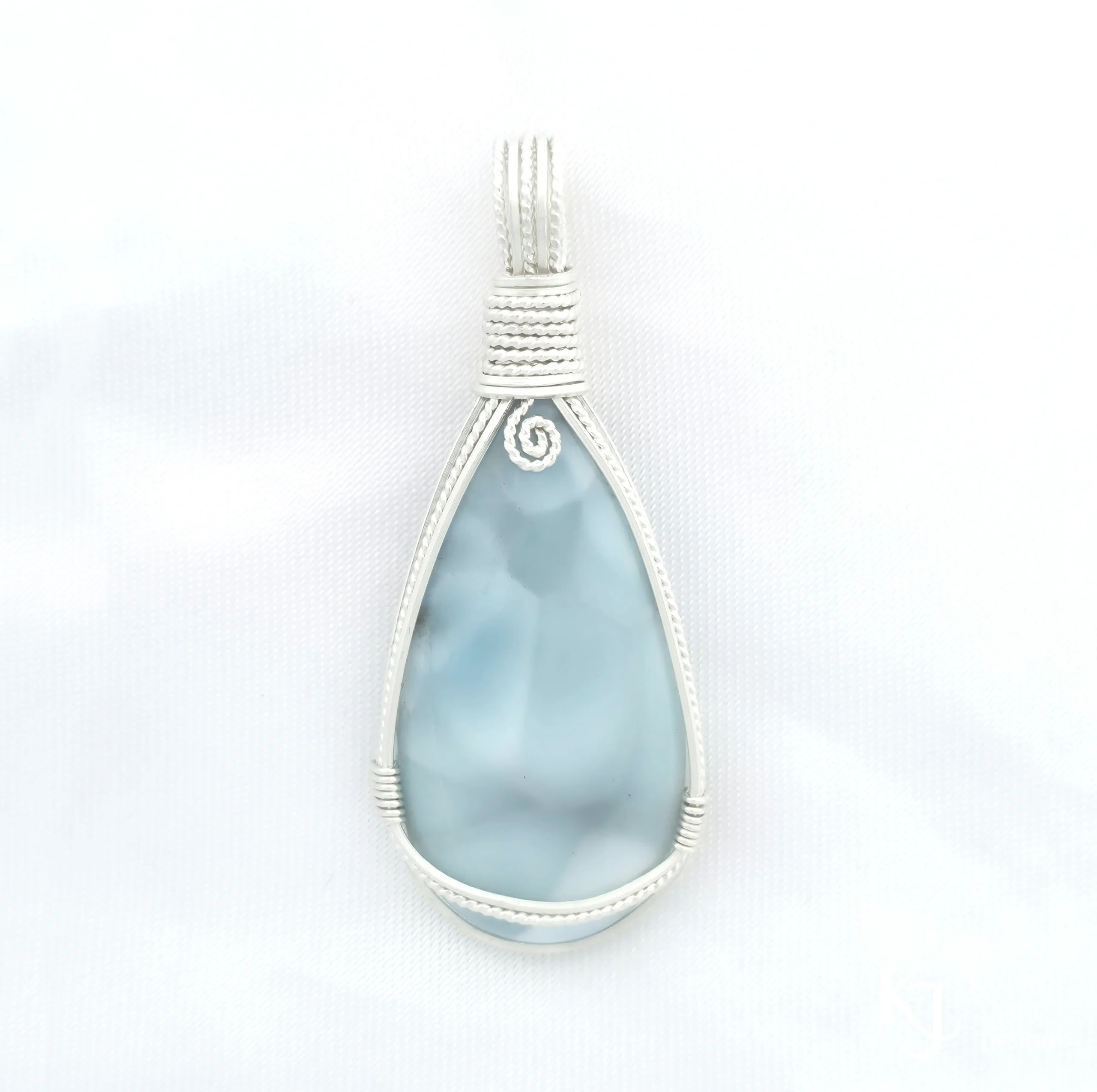 Peardrop-shaped larimar pendant, soft blue-turqoise, framed in sterling silver wire. Kathryn Jane Design