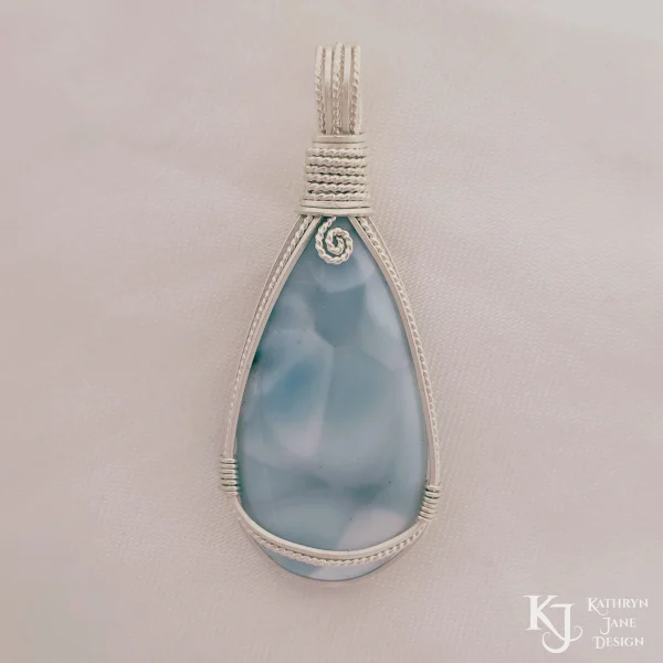 Peardrop-shaped larimar pendant, soft blue-turqoise, framed in sterling silver wire. Kathryn Jane Design