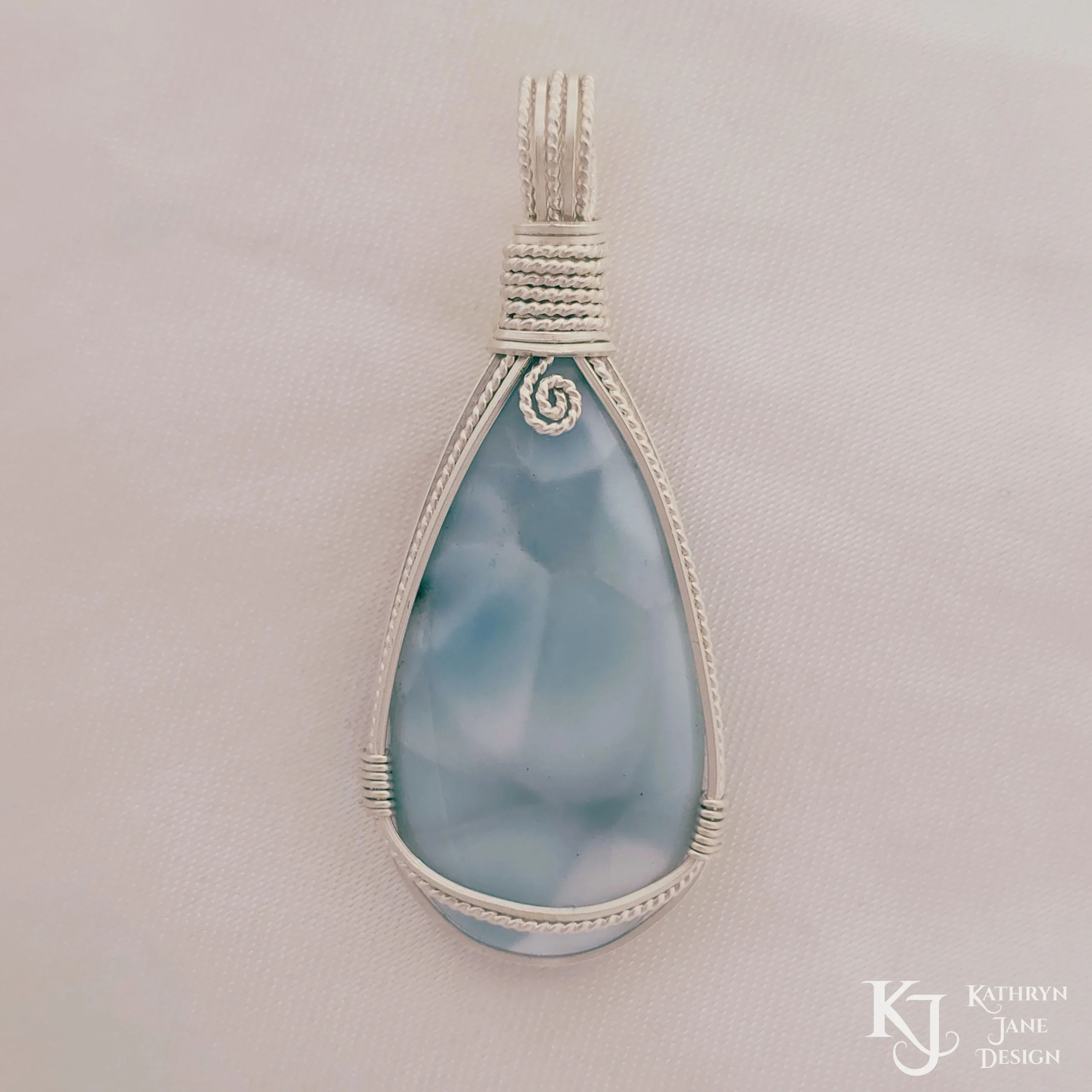 Peardrop-shaped larimar pendant, soft blue-turqoise, framed in sterling silver wire. Kathryn Jane Design
