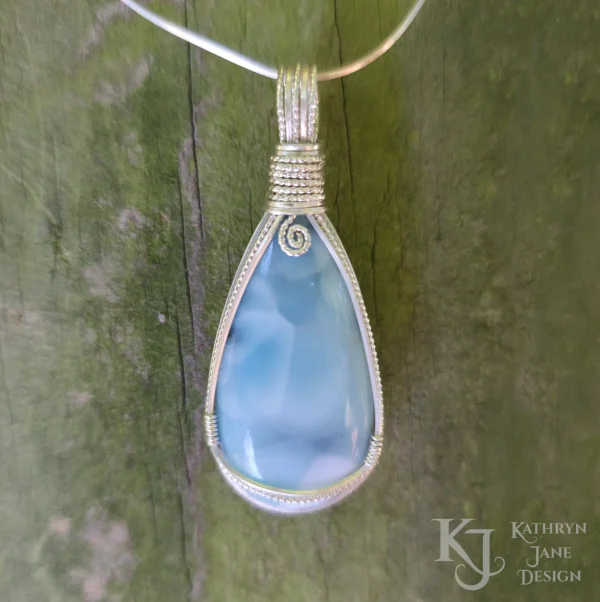 Peardrop-shaped larimar pendant, soft blue-turqoise, framed in sterling silver wire. Kathryn Jane Design wire wrapped pendant.