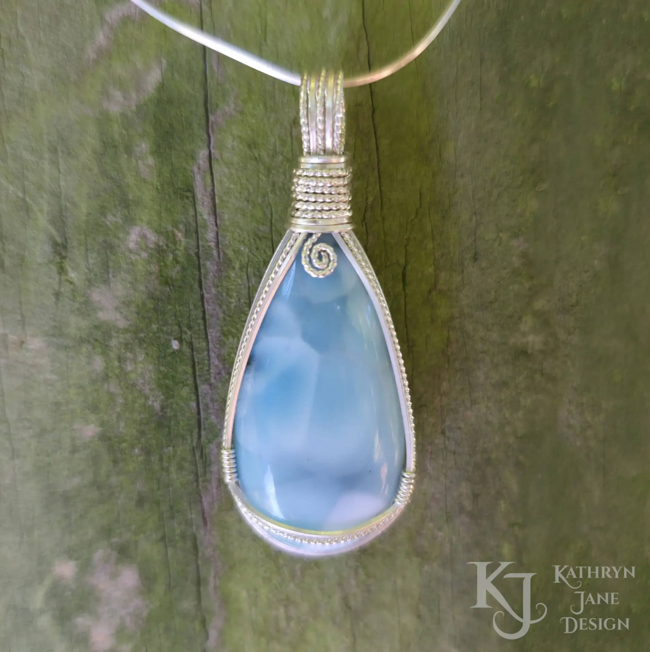 Peardrop-shaped larimar pendant, soft blue-turqoise, framed in sterling silver wire. Kathryn Jane Design wire wrapped pendant.