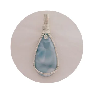 Peardrop-shaped larimar pendant, soft blue-turqoise, framed in sterling silver wire. Kathryn Jane Design wire-wrapped pendant. White circular frame