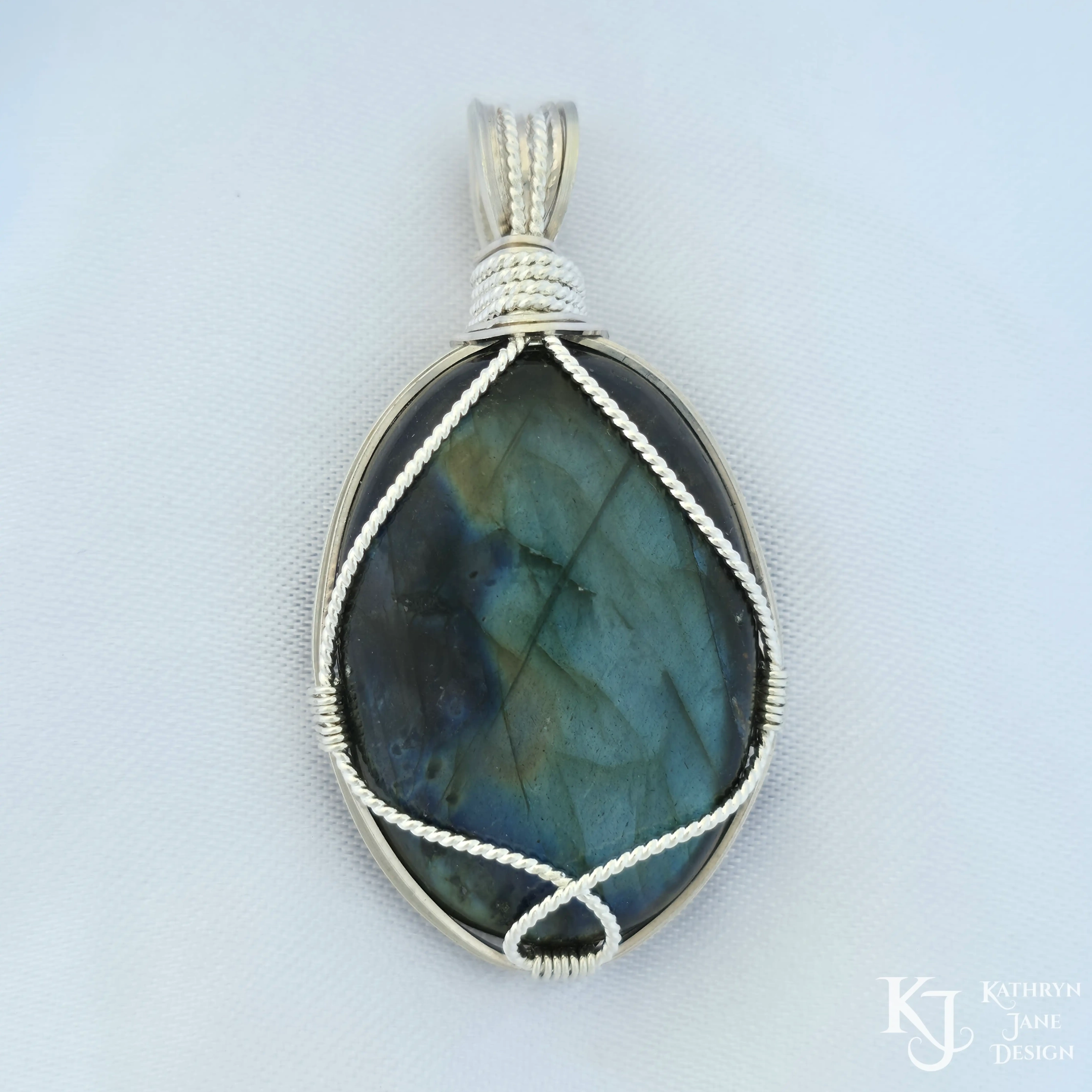 Kathryn Jane Design wire-wrapped labradorite pendant with sterling silver forming a framework. White background.