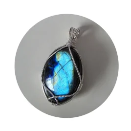Kathryn Jane Design wire-wrapped labradorite pendant with sterling silver forming a framework. White background.