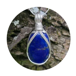 Kathryn Jane Design wire-wrapped lapis lazuli pendant with sterling silver forming a framework. Bark background.