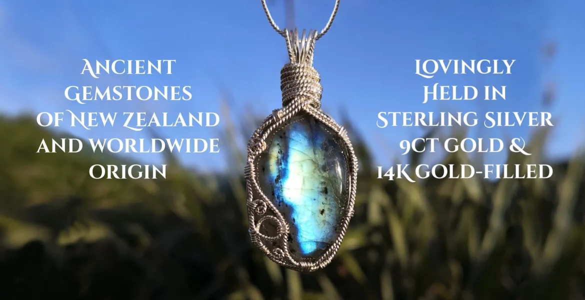 labradorite pendant surrounded by silver, blue sky top background and flaxes down below. Ancient gemstones of New Zealand and worldwide origin lovingly held in sterling silver, 9ct gold and 14k gold-filled