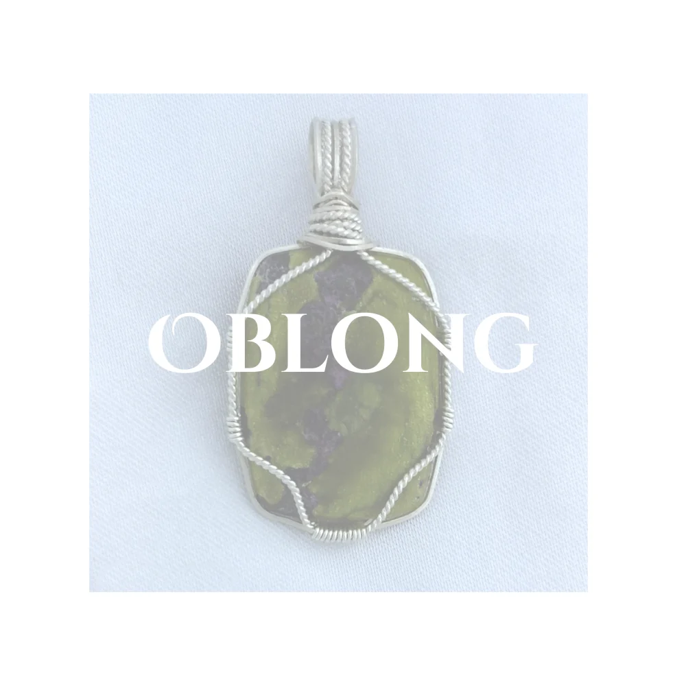 Oblong title over whited out Atlantisite (also called stichtite in serpentine) pendant. The front is suported by a single twisted silver strand.