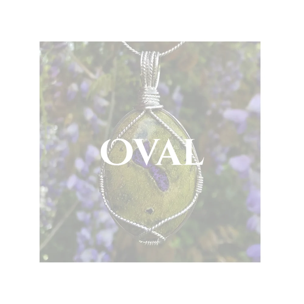 Oval title over a whited out photo of peardrop-shaped Atlantisite pendant, (also known as stichtite in serpentine), with single twisted silver strand support. Heading page for gallery of oval-shaped handcrafted crystal pendants by Kathryn Jane Design
