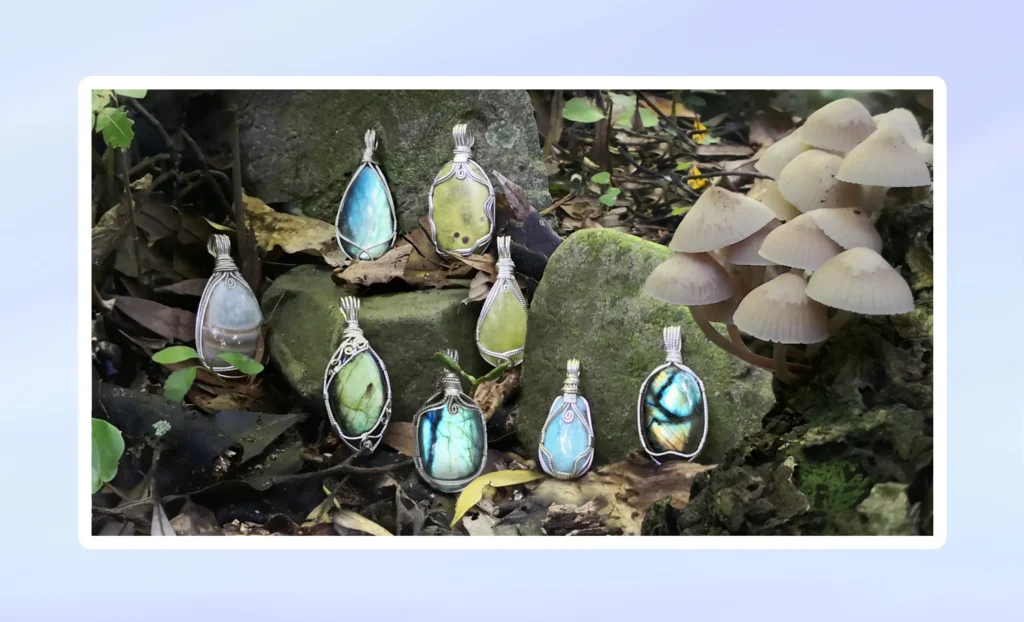 Pendants category image. View available Kathryn Jane Design gemstone pendants. Natural gemstone crystal pendants, wire-wrapped in sterling silver, on stones of riverbed, surrounded by leaves. Crystals include Atlantisite (stichtite in serpentine), labradorite, prehnite and larimar.